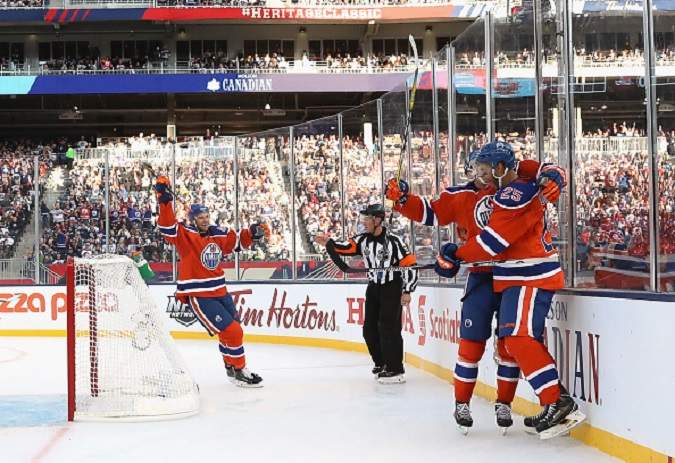 Darnell Nurse of the Edmonton Oilers celebrates his second period goal with teammates during the 2016 Tim Hortons NHL Heritage Classic at Investors Group Field.