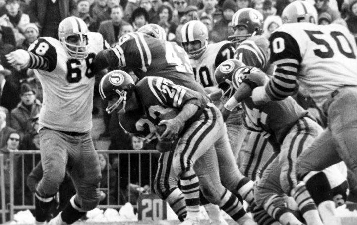 Roughrider Ron Lancaster hangs onto the ball as he is caught behind the line on Dec. 2, 1967.