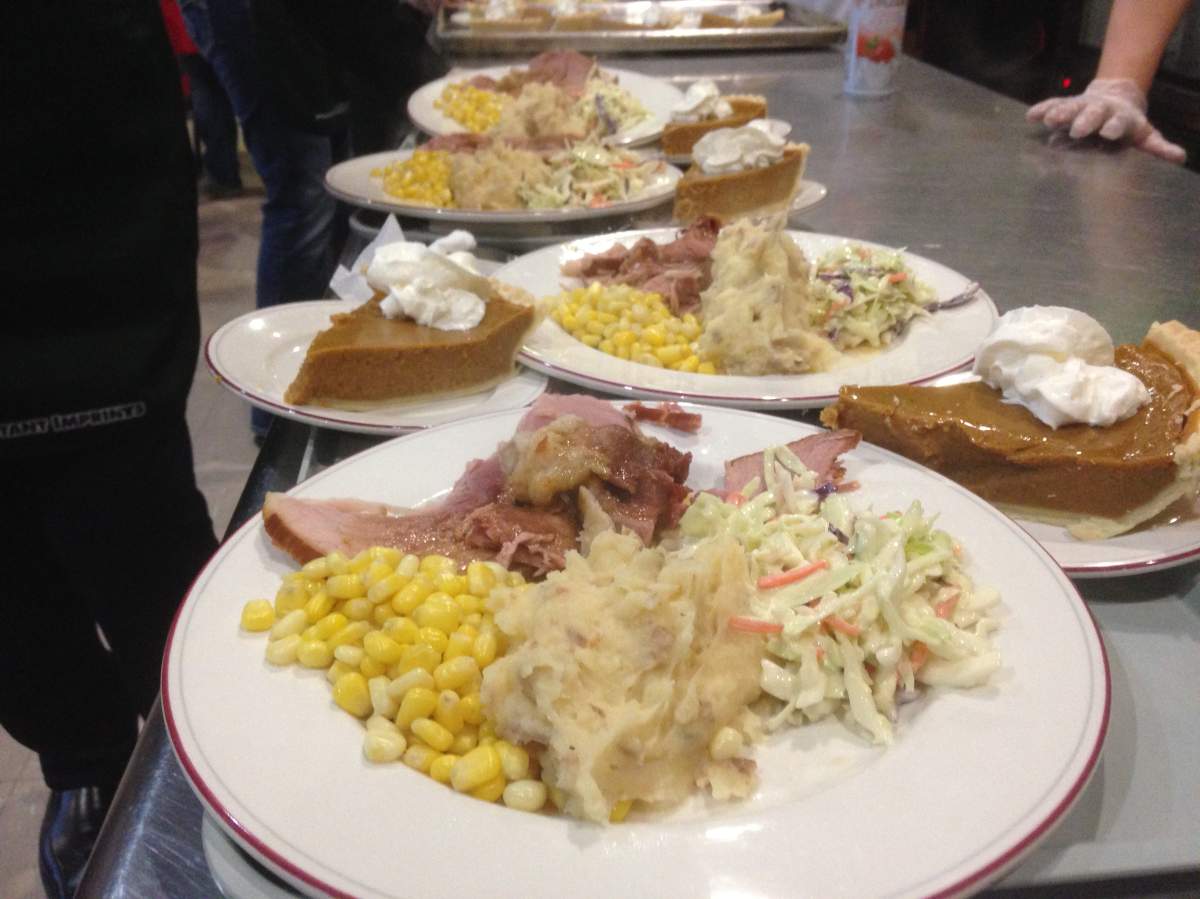 The meal consists of ham, potatoes, corn and pumpkin pie.
