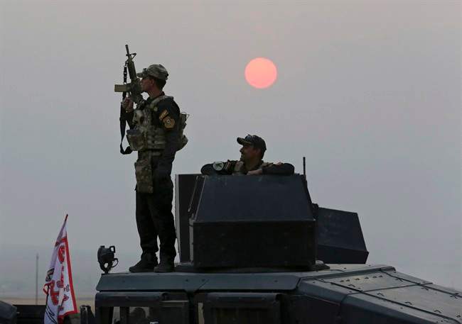Iraq's elite counterterrorism forces advance toward Islamic State positions as fighting to retake the extremist-held city of Mosul enters its second week, in the village of Tob Zawa, outside Mosul, Monday, Oct. 24, 2016. A convoy of special forces advanced toward the village of Tob Zawa, Monday, encountering roadside bombs and trading heavy fire with the militants. Loudspeakers on the Humvees blared Iraqi patriotic music as they pushed toward the village.