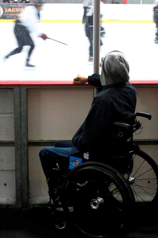 In this Sunday, Aug. 28, 2016 photo, Jonathan Annicks watches his brother’s ice hockey team play in a recreational league game in Romeoville, Ill.