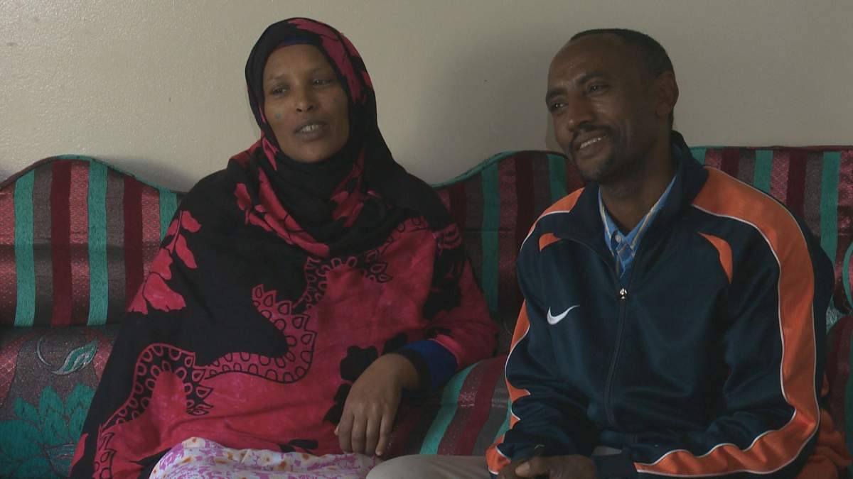 Hussein Turi and his pregnant wife Hugitu sit in their living room after being poisoned by carbon monoxide on Friday morning in south Edmonton.