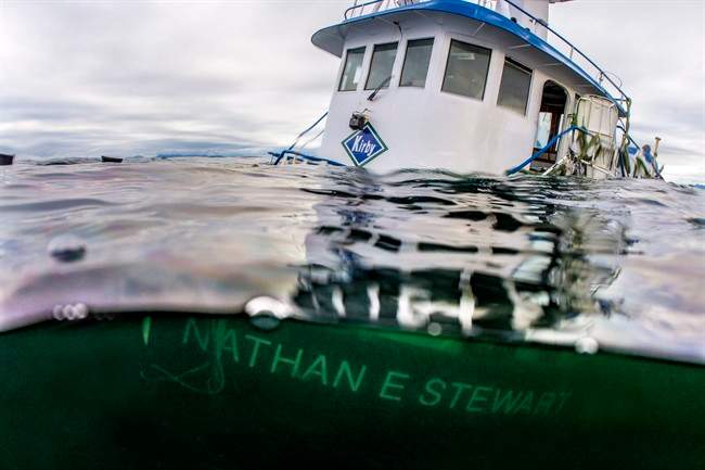 The sinking of a tug and the subsequent diesel spill on British Columbia's central coast is prompting a rethink to emergency response that could allow those closest to the disaster to take the lead, says the federal indigenous affairs minister. The tug boat Nathan E. Stewart is seen in the waters of the Seaforth Channel near Bella Bella, B.C., in an October 23, 2016, handout photo.