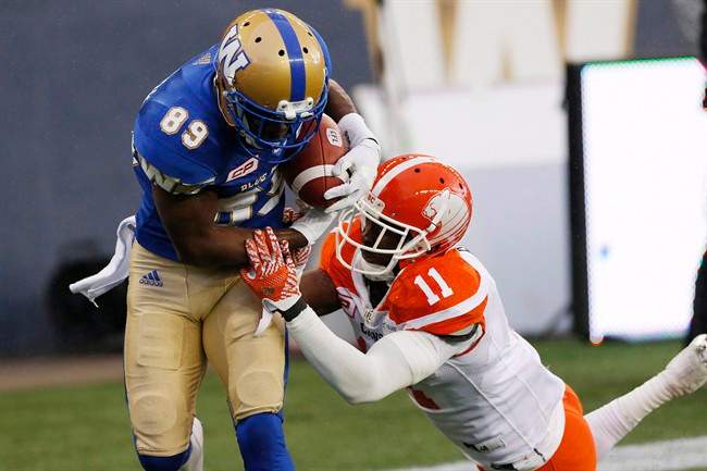 B.C. Lions' Mike Edem can't stop Winnipeg Blue Bombers' Clarence Denmark from hauling in the winning touchdown pass during the second half of a CFL game action in Winnipeg on Oct. 8, 2016.
