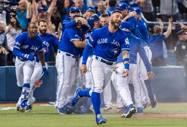 Toronto Blue Jays' Kevin Pillar and his team celebrate their walk-off win to eliminate the Texas Rangers during the tenth inning to win the American League Division Series in Toronto on Sunday, October 9, 2016.