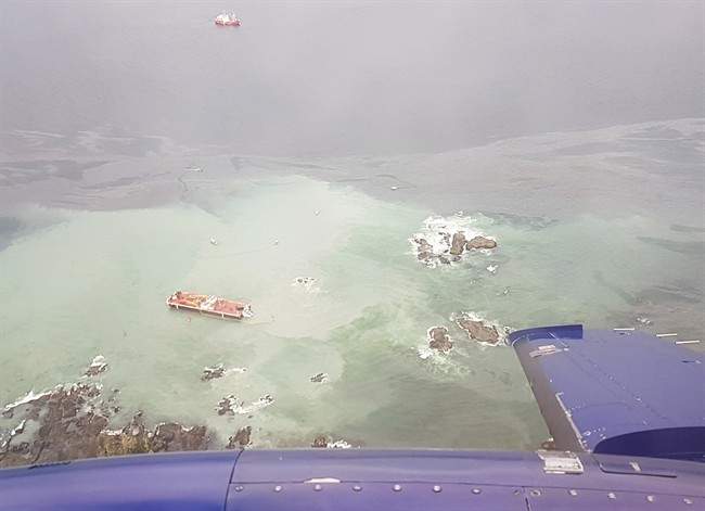 A tug boat that ran aground near British Columbia's Great Bear Rainforest is seen on Thursday, Oct. 13, 2016 in this aerial handout photo. A tug boat that ran aground and sank near British Columbia's Great Bear Rainforest is leaking diesel fuel, which the coast guard says is expected to dissipate.