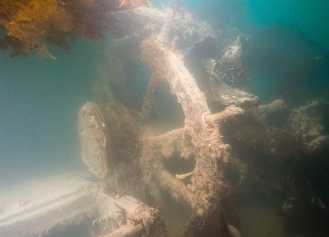The ship's helm (wheel) astern of the skylight for the captain's cabin of the HMS Terror is seen.