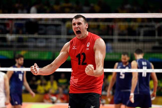 Canada's Gavin Schmitt celebrates a win after a men's preliminary volleyball match against Italy at the 2016 Summer Olympics in Rio de Janeiro, Brazil, Monday, Aug. 15, 2016. Canadian men's volleyball star Schmitt has announced his retirement from the national team after helping the country to a quarter-final berth at the Olympic Games.