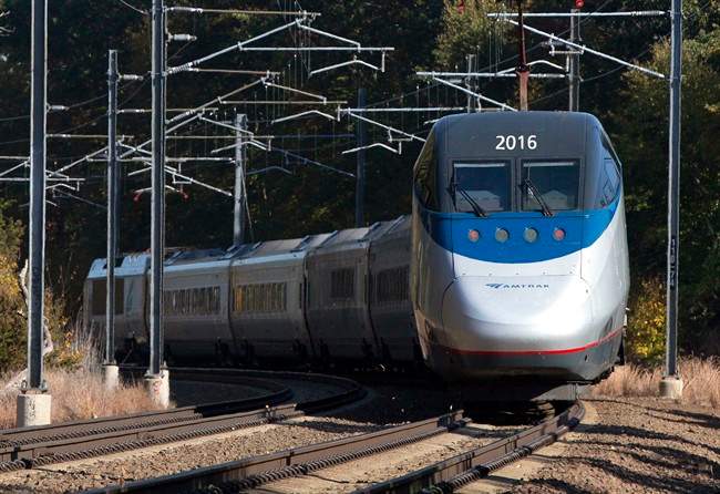 In this Tuesday, Oct. 18, 2016 photo, an Amtrak Acela train travels through Old Lyme, Conn. A plan to speed up Amtrak's high-speed rail corridor from Boston to Washington, D.C., is welcomed by business commuters but finding its strongest opposition in some shoreline towns in Connecticut. (AP Photo/Michael Dwyer).