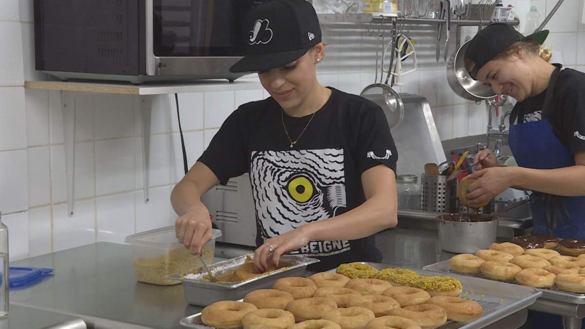 Doughnuts are being decorated at the Trou de Beigne shop in Little Italy. Wednesday, Oct. 12, 2016.