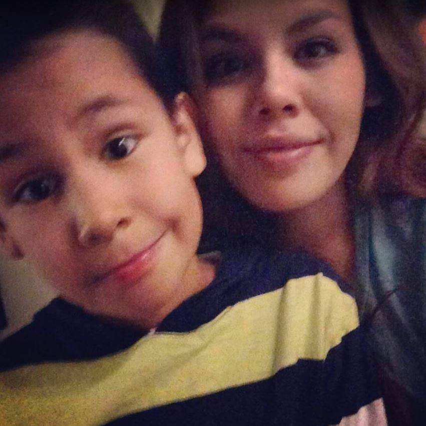 Adrienne takes a selfie with her son.