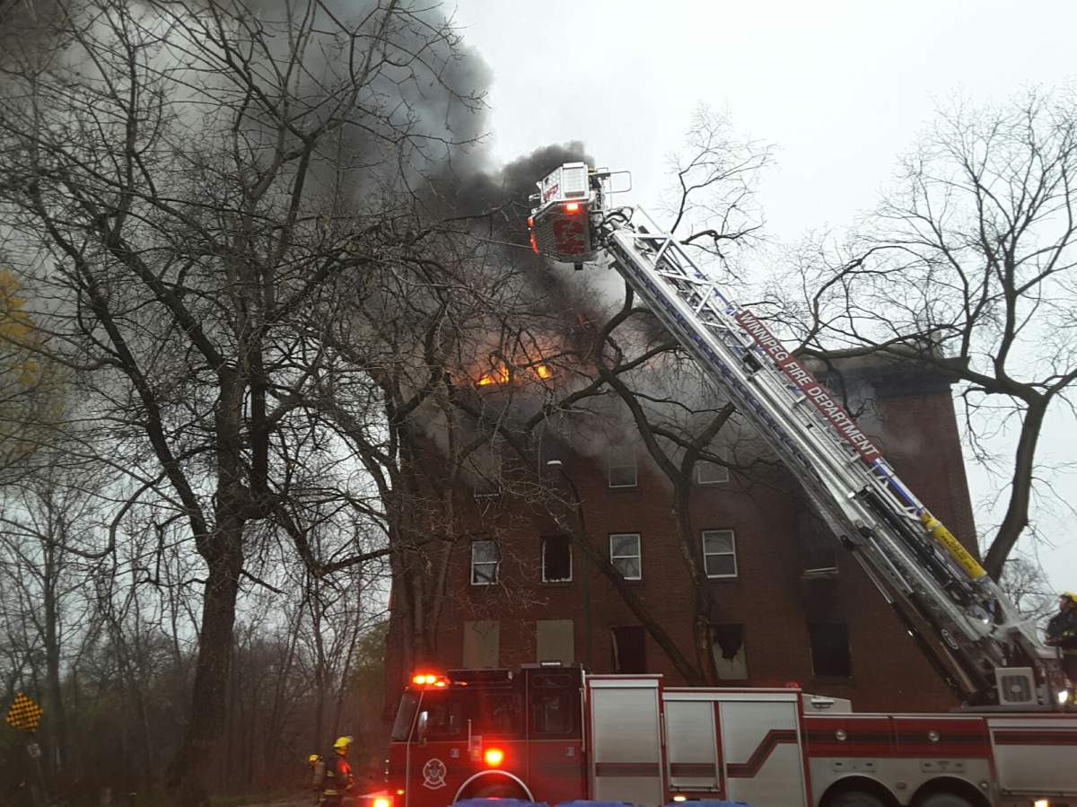 Flames shoot from the top storey of a building in Winnipeg's downtown. 