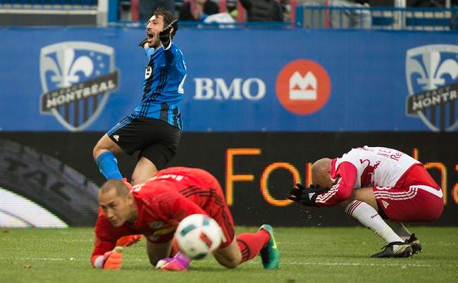 New York Red Bulls goalkeeper Luis Robles and Aurelien Collin, right, react as Montreal Impact's Matteo Mancosu celebrates after scoring during second half action of the first leg of the eastern conference MLS soccer semifinal in Montreal, Sunday, October 30, 2016.