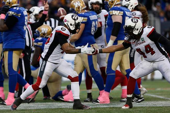 Ottawa Redblacks' Damaso Munoz (45) and Taylor Reed (44) celebrate Munoz's sack of Winnipeg Blue Bombers quarterback Matt Nichols (15) during the second half of CFL action in Winnipeg Saturday, October 29, 2016.