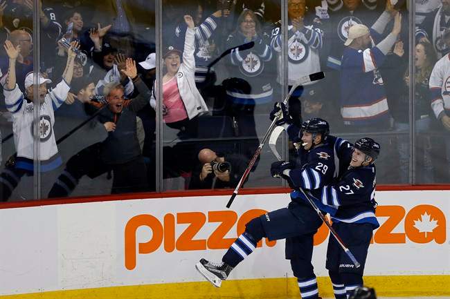 Winnipeg Jets' Nikolaj Ehlers (27) and Patrik Laine (29) celebrate Patrik Laine's (29) game winning goal and hat-trick during overtime against the Toronto Maple Leafs in NHL action in Winnipeg on Wednesday, October 19, 2016. 