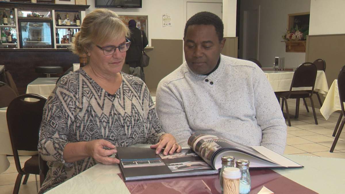 Peggy and Julio Rivera flip through a book they compiled about their experience in Haiti during the 2010 earthquake.