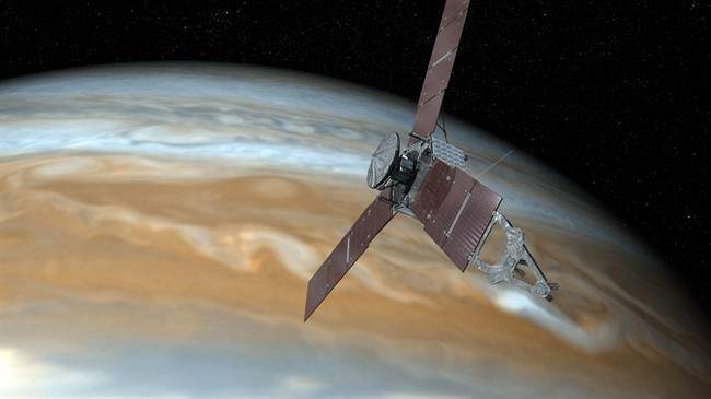 This undated artist's rendering shows NASA's Juno spacecraft making one of its close passes over Jupiter.