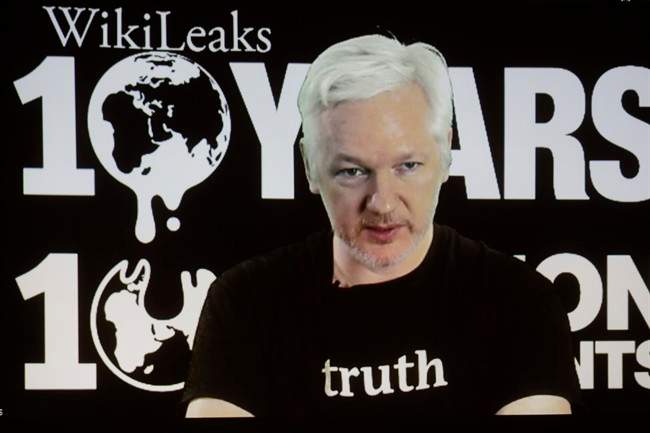 In this Oct. 4, 2016 file photo, WikiLeaks founder Julian Assange participates via video link at a news conference marking the 10th anniversary of the secrecy-spilling group in Berlin. WikiLeaks said on Monday, Oct. 17, 2016, that Assange's internet access has been cut by an unidentified state actor. (AP Photo/Markus Schreiber, File).