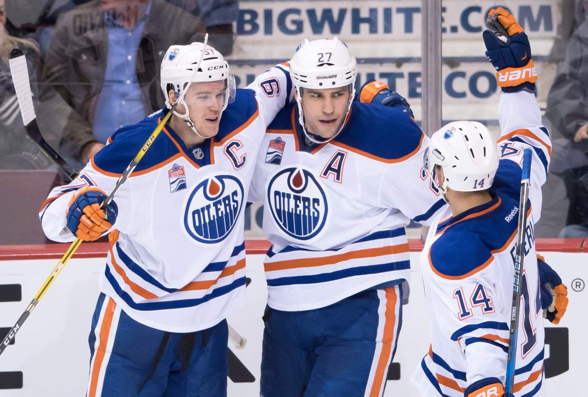 Edmonton Oilers' Connor McDavid, from left to right, Milan Lucic and Jordan Eberle celebrate Lucic's empty net goal against the Vancouver Canucks during the third period of an NHL hockey game in Vancouver, B.C., on Friday October 28, 2016. THE CANADIAN PRESS/Darryl Dyck.