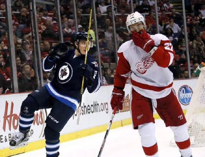 Winnipeg Jets' Marko Dano, left, of Austria, celebrates his goal during the first period of an NHL hockey game as Detroit Red Wings' Kyle Quincey (27) skates away, Thursday, March 10, 2016, in Detroit.