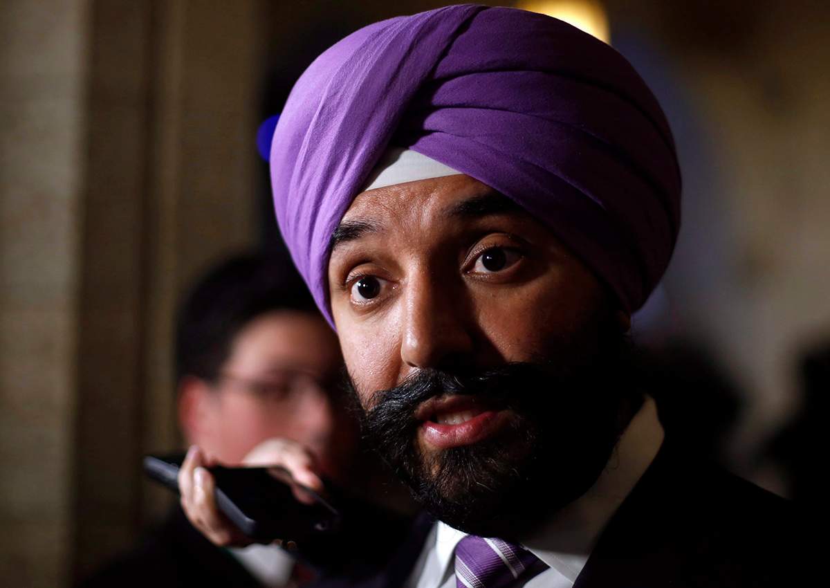Navdeep Bains, Minister of Innovation, Science and Economic Development, talks to reporters in foyer of the House of Commons in Ottawa, to comment on the job cuts announcement made by Bombardier on Friday, October 21 2016. 