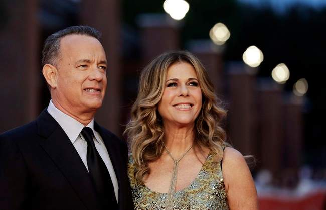 Actor Tom Hanks, left, flanked by his wife Rita Wilson, arrives to receive a lifetime achievement at the Rome Film Festival, in Rome.