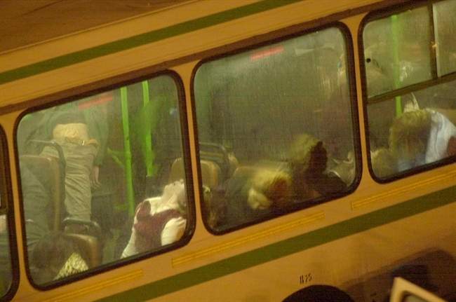 FILE – In this early Saturday, Oct. 26, 2002 file photo, unconscious liberated hostages are taken away in a bus from the scene near the Dubrovka Theater in Moscow. Russian special forces turned to carfentanil to end a standoff with Chechen separatists using an aerosol version of the opioid, along with the less potent remifentanil, sending it through air vents, according to a paper by British scientists who tested clothing and urine samples from three survivors. The strategy worked, but more than 120 hostages died from the effects of the chemicals.