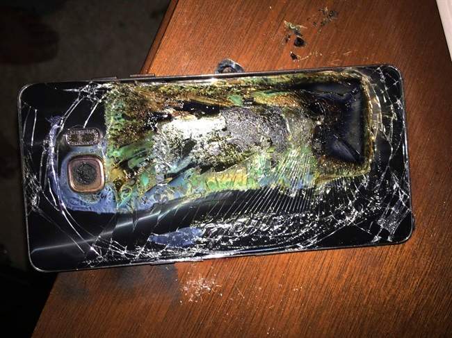 This Sunday, Oct. 9, 2016, photo shows a damaged Samsung Galaxy Note 7 on a table in Richmond, Va., after it caught fire earlier in the day. Samsung Electronics said Tuesday, Oct. 11, that it is discontinuing production of Galaxy Note 7 smartphones permanently, a day after stopping global sales of the ill-fated devices. (Shawn L. Minter via AP).