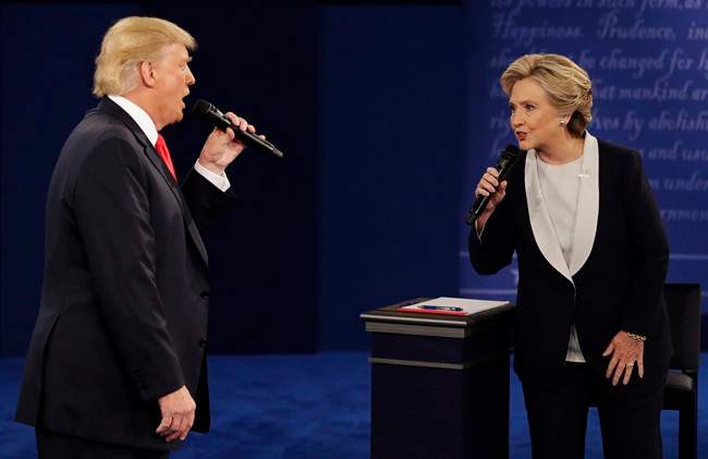 Republican presidential nominee Donald Trump and Democratic presidential nominee Hillary Clinton speak during the second presidential debate at Washington University in St. Louis. (AP Photo/John Locher, File).