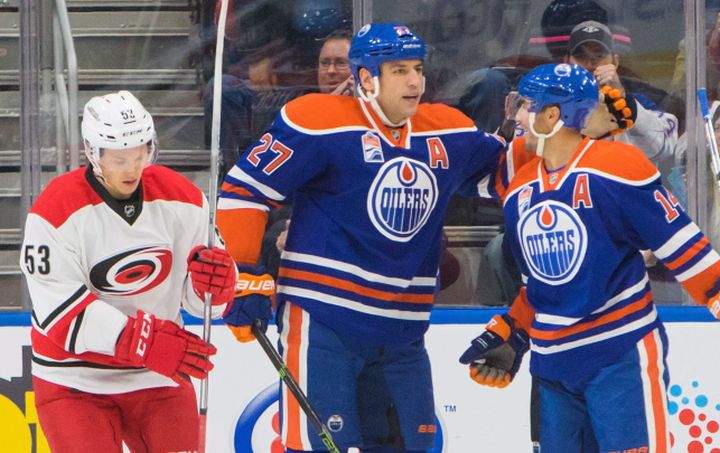 Carolina Hurricanes' Jeff Skinner (53) skates off as Edmonton Oilers' Milan Lucic (27) and Jordan Eberle (14) celebrate Eberle's goal during first period NHL hockey action in Edmonton, Alta., on Tuesday October 18, 2016. 