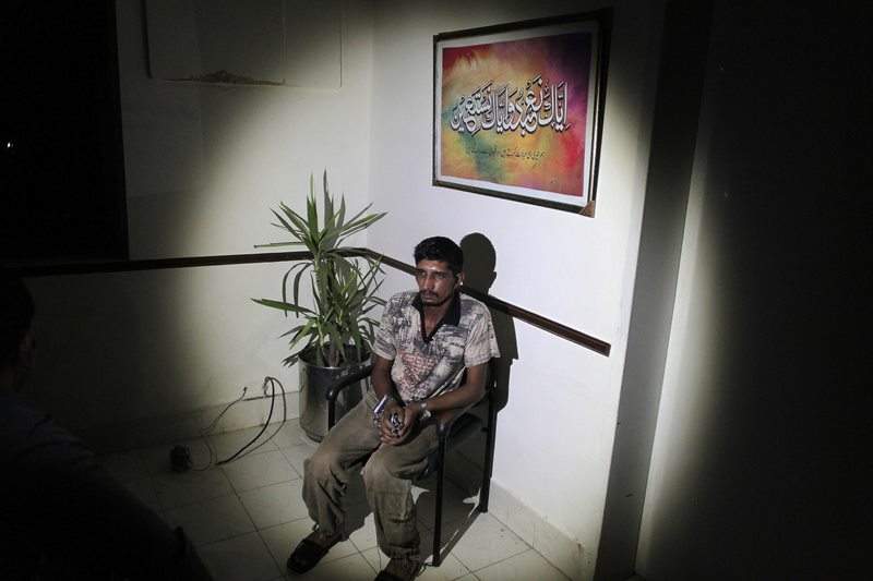 In this photo taken on Thursday, Sept. 1, 2016, Mubeen Rajhu, who killed his sister Tasneem sits at police headquarters in Lahore, Pakistan. 