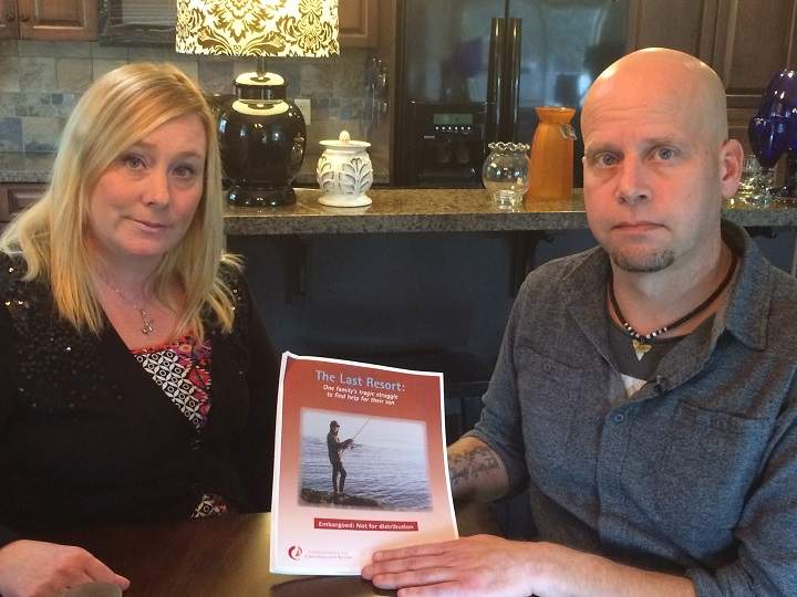 Nick Lang’s parents, Linda Tenpas and Peter Lang hold a copy of the recent report.