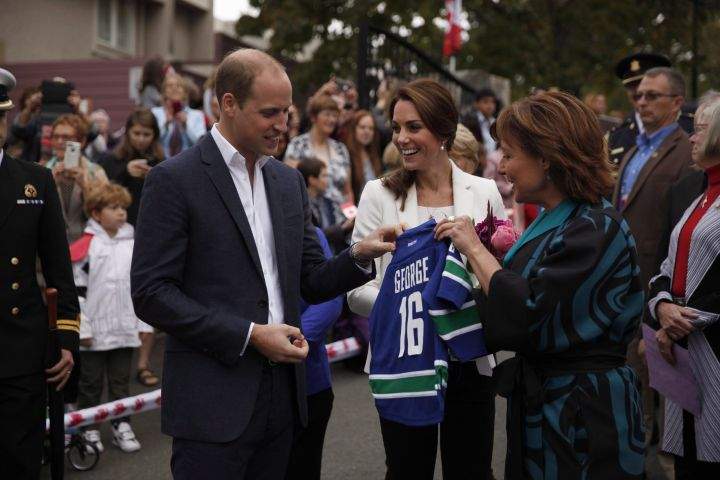B.C. Premier Christy Clark gives Vancouver Canucks jerseys with the names of their kids, George and Charlotte, to the Duke and Duchess of Cambridge following their visit to the Cridge Centre for the Family during a tour of the centre in Victoria, B.C., Saturday, Oct. 1, 2016.