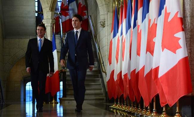Canadian Prime Minister Justin Trudeau and French Prime Minister Manuel Valls walk to a joint media availability on Parliament Hill in Ottawa, Thursday October 13, 2016.
