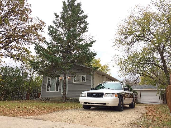 A police car sits in a Springfield Road driveway Thursday morning. 