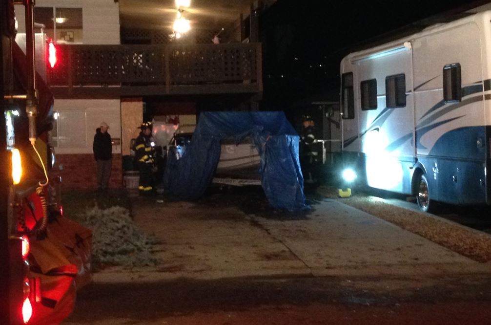 The homeowners used a garden hose to extinguish the flames that engulfed their boat.