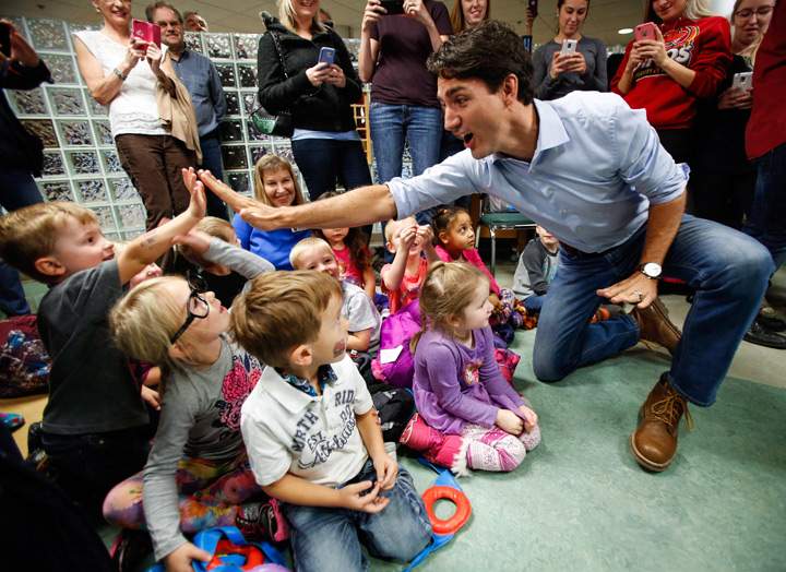 Prime Minister Justin Trudeau high fives pre-schoolers