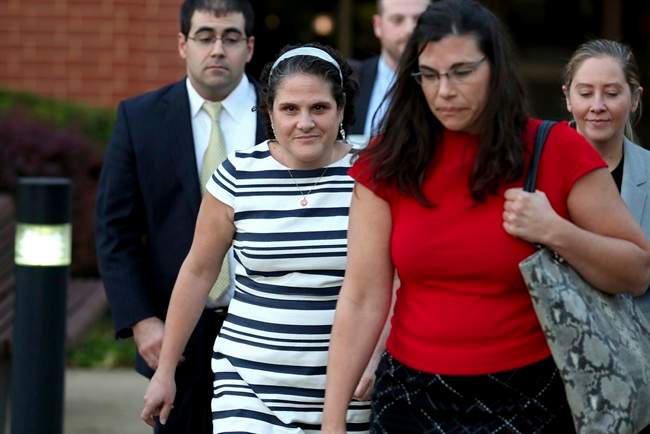 Nicole Eramo, center, leaves the federal courthouse, Wednesday, Oct. 19, 2016 in Charlottesville, Va.. Eramo, a University of Virginia administrator who sued Rolling Stone magazine over its portrayal of her in a now-discredited story about a gang rape said Wednesday that the magazine's apologies for its journalistic failures didn't go far enough. (Ryan M. Kelly/The Daily Progress via AP).