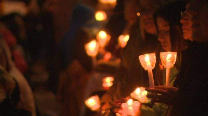 People are quiet as they hold candles to honour missing and murdered indigenous women