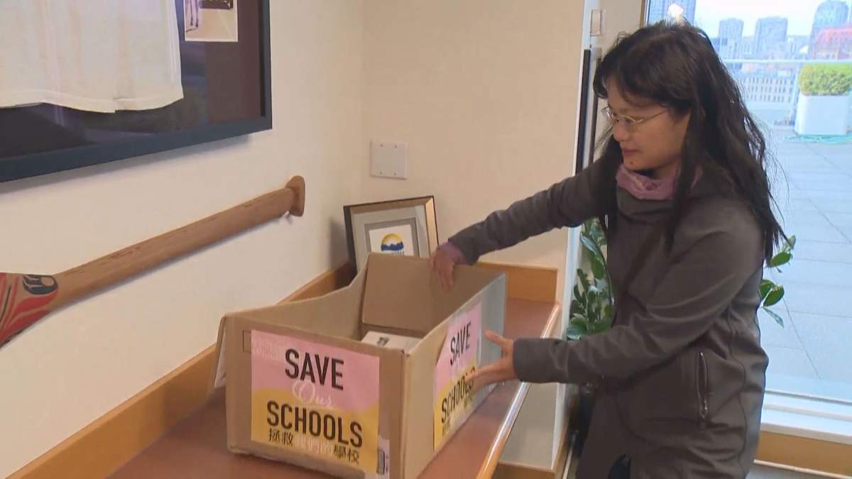 A concerned parent drops a box of “Save Our Schools” petitions at the Vancouver offices of the provincial government on Oct. 18, 2016.