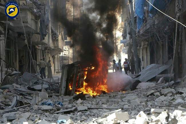 In this photo provided by the Syrian Civil Defense group known as the White Helmets, Syrians inspect damaged buildings after airstrikes by government helicopters on the rebel-held Aleppo neighbourhood of Mashhad, Syria, Tuesday Sept. 27, 2016. 