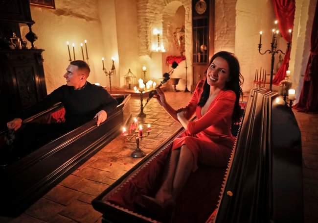Events manager Tami Varma and her brother Robin, a PhD student, the grandchildren of Devendra Varma, a scholar of English gothic tales and an expert in vampire lore, pose in coffins at Bran Castle, in Bran, Romania, Monday, Oct. 31, 2016. A Canadian brother and sister are passing Halloween night curled up in red velvet coffins in the Transylvanian castle that inspired the Dracula legend, the first time in 70 years anyone has spent the night in the gothic fortress after they bested 88,000 people who entered a competition hosted by Airbnb to get the chance to dine and sleep at the castle in Romania. 