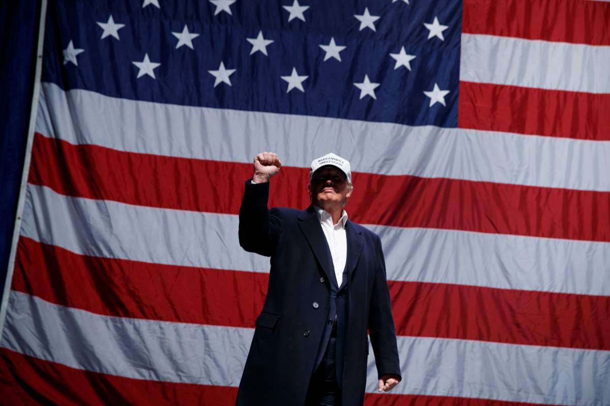 Republican presidential candidate Donald Trump pumps his fist as he arrives to speak to a campaign rally, Sunday, Nov. 6, 2016, in Sterling Heights, Mich. 