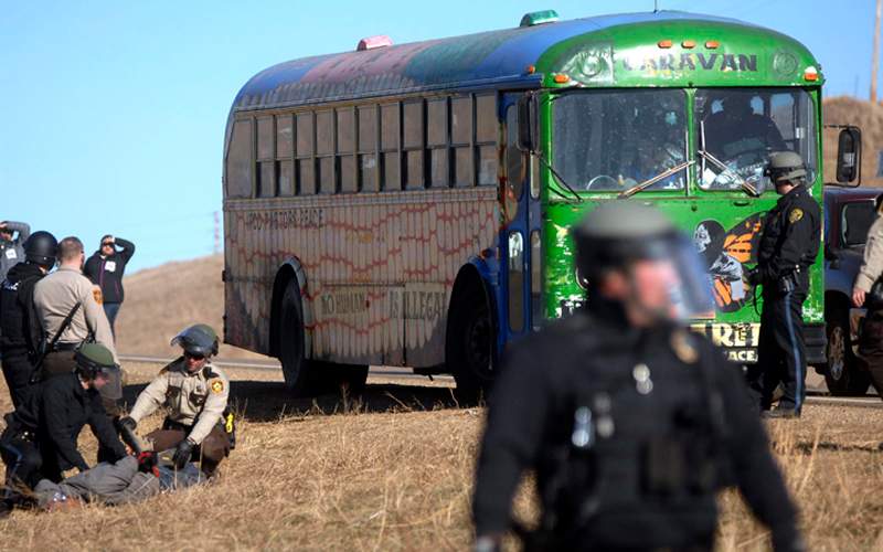 Law enforcement officers arrest a Dakota Access Pipeline protester, far left, during a clash at a pipeline construction site south of St. Anthony, N.D. Friday, Nov. 11, 2016.