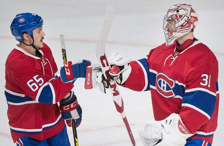 Montreal Canadiens goaltender Carey Price celebrates with teammate Andrew Shaw, left, after defeating the Detroit Red Wings in an NHL hockey game in Montreal, Saturday, November 12, 2016. THE CANADIAN PRESS/Graham Hughes