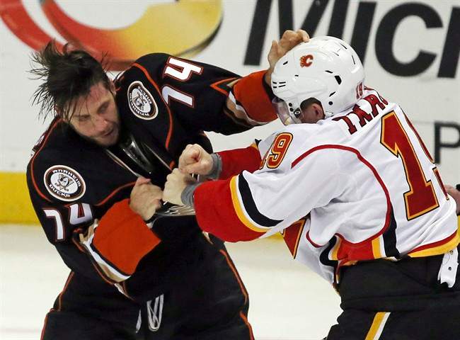 Anaheim Ducks left winger Joseph Cramarossa (74) and Calgary Flames left winger Matthew Tkachuk (19) fight in the second period of an NHL hockey game in Anaheim, Calif., Sunday, Nov. 6, 2016. 