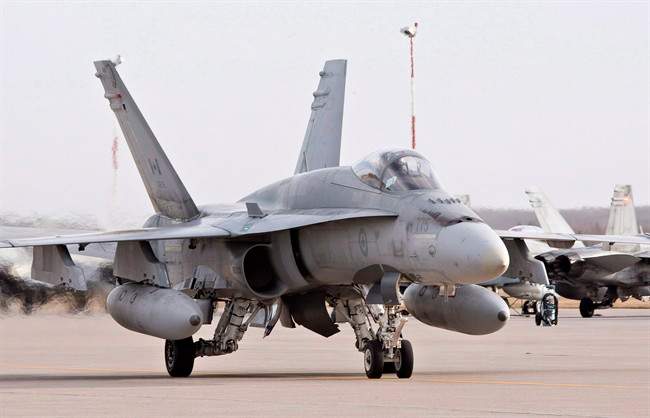 A pilot positions a CF-18 Hornet at the CFB Cold Lake, in Cold Lake, Alberta on Tuesday, October 21, 2014.