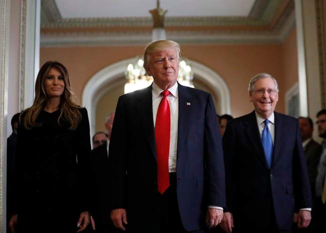 President-elect Donald Trump and his wife Melania walk with Senate Majority Leader Mitch McConnell of Ky. after a meeting on Capitol Hill on Nov. 10, 2016.