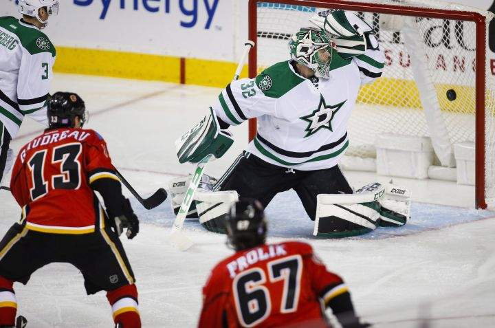 Dallas Stars goalie Kari Lehtonen, right, from Finland, looks back as Calgary Flames' Johnny Gaudreau scores during second period NHL hockey action in Calgary, Thursday, Nov. 10, 2016. 