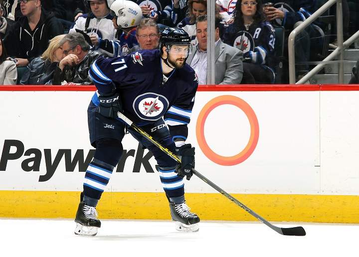Julian Melchiori of the Winnipeg Jets gets set for a first period face-off against the Chicago Blackhawks at MTS Centre on April 1, 2016.